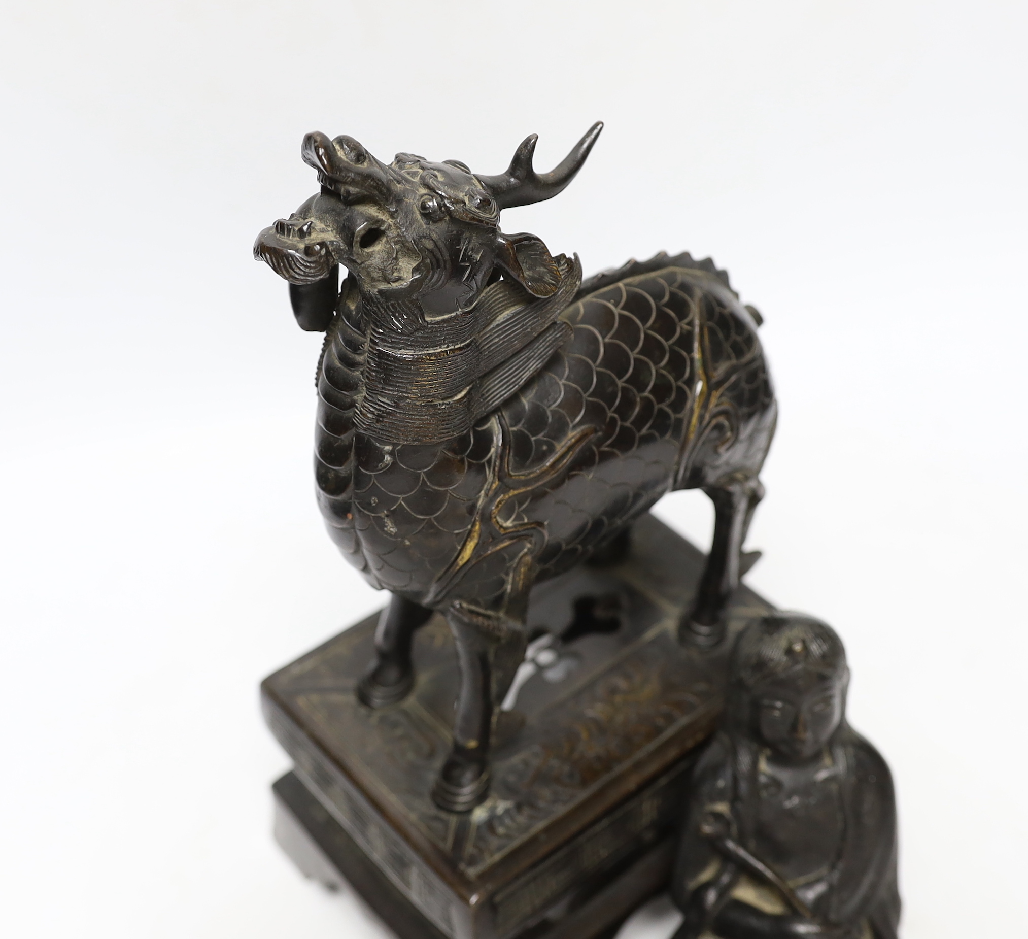 An 18th century Chinese bronze figure of a qilin together with a Japanese figural bronze mount, tallest 25cm